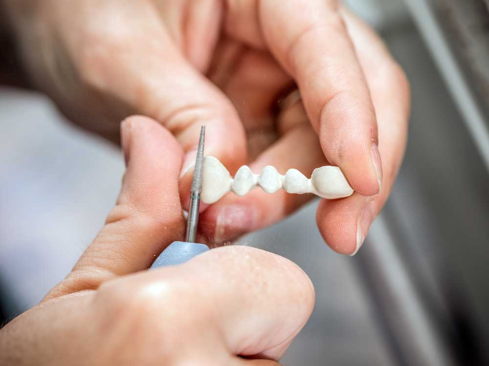dental technician molding teeth