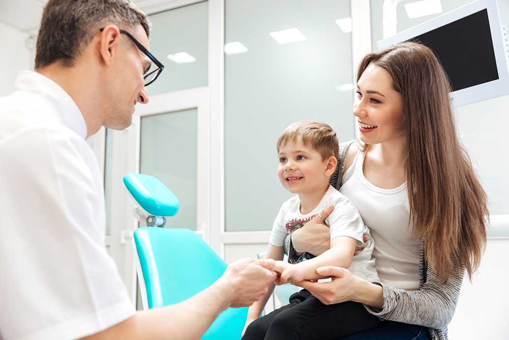 Mother and Little son visiting the dentist